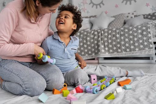 Mother and child playing with colourful blocks